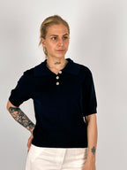 Polo donna in maglia nero con colletto classico e bottoni frontali - vista frontale