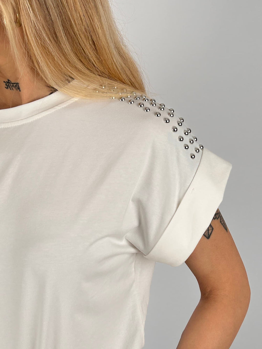 T-shirt donna con micro borchie decorative sulle spalle e vestibilità morbida stile casual chic. vista dettaglio bianco